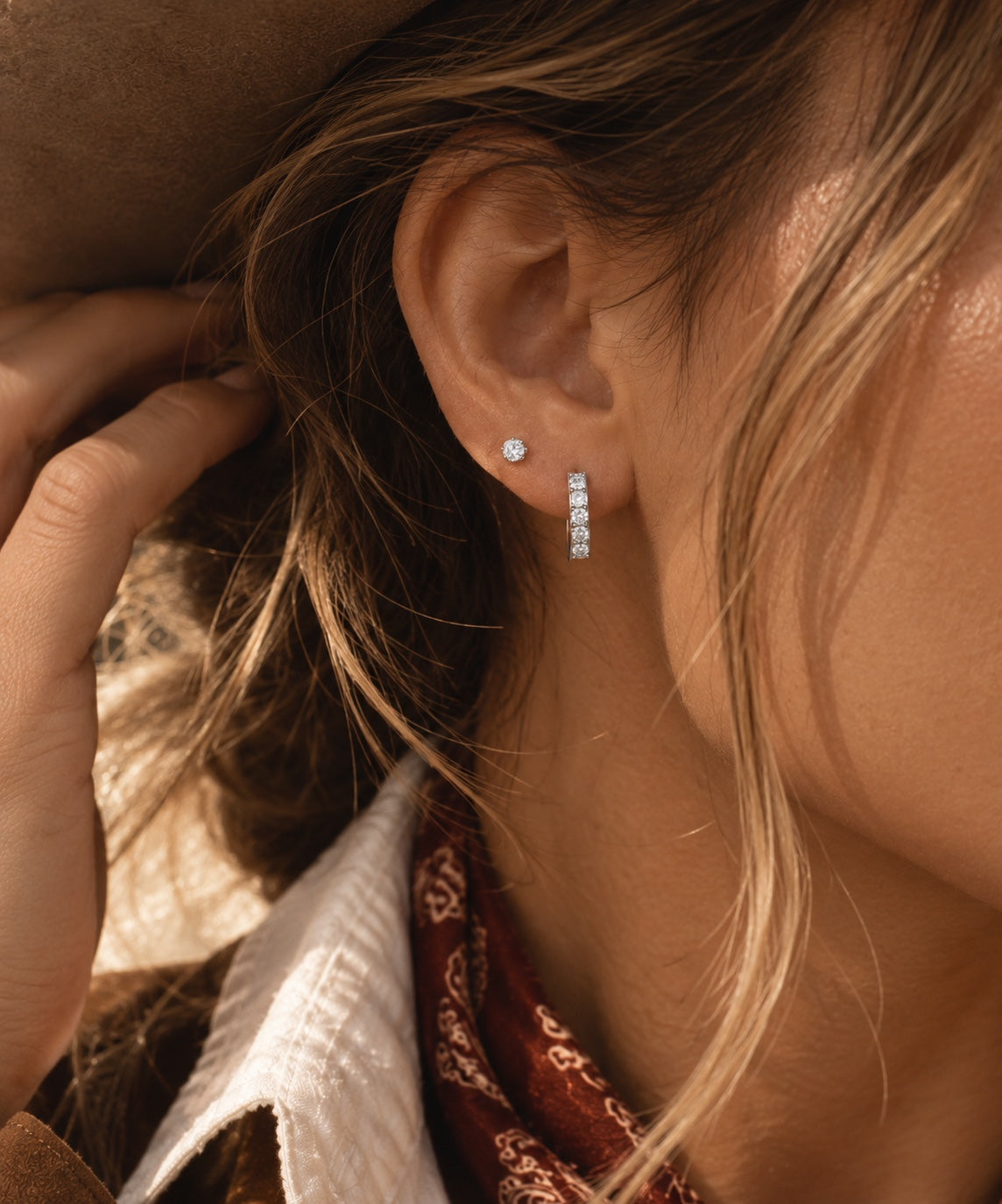Noelle huggie earrings worn close-up