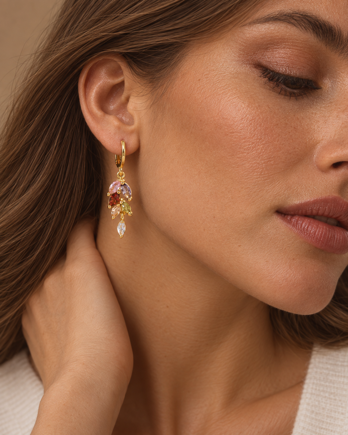 Close-up of gold-tone multicolor zircon drop earring
