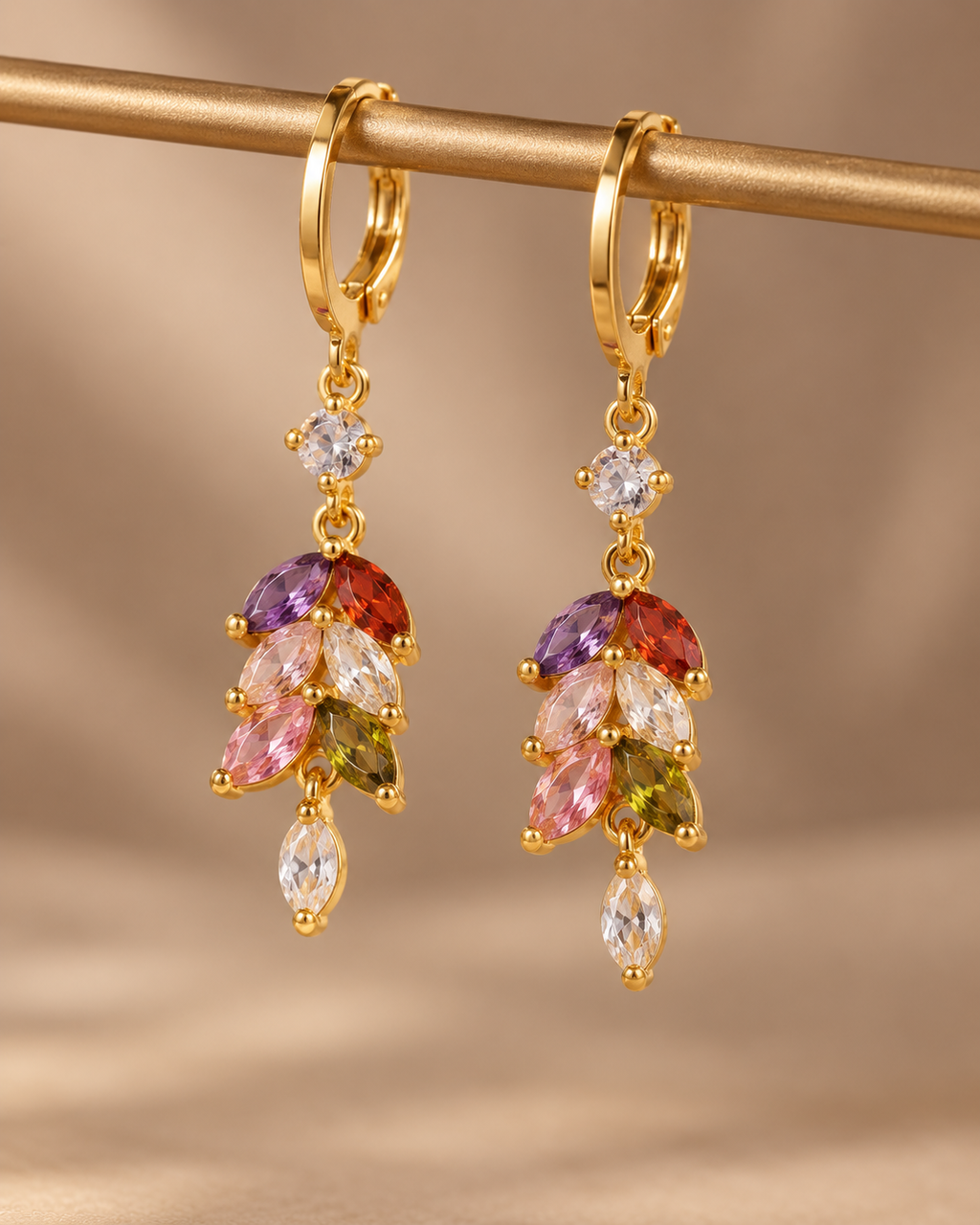 Gold-tone multicolor zircon drop earrings on display stand
