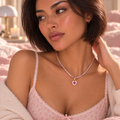 Close-up of lavender tennis necklace with pink heart pendant