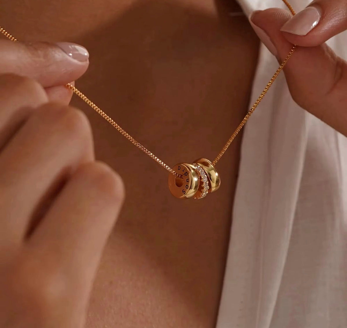 The Lyra personalized engraved name bead necklace in gold worn on model