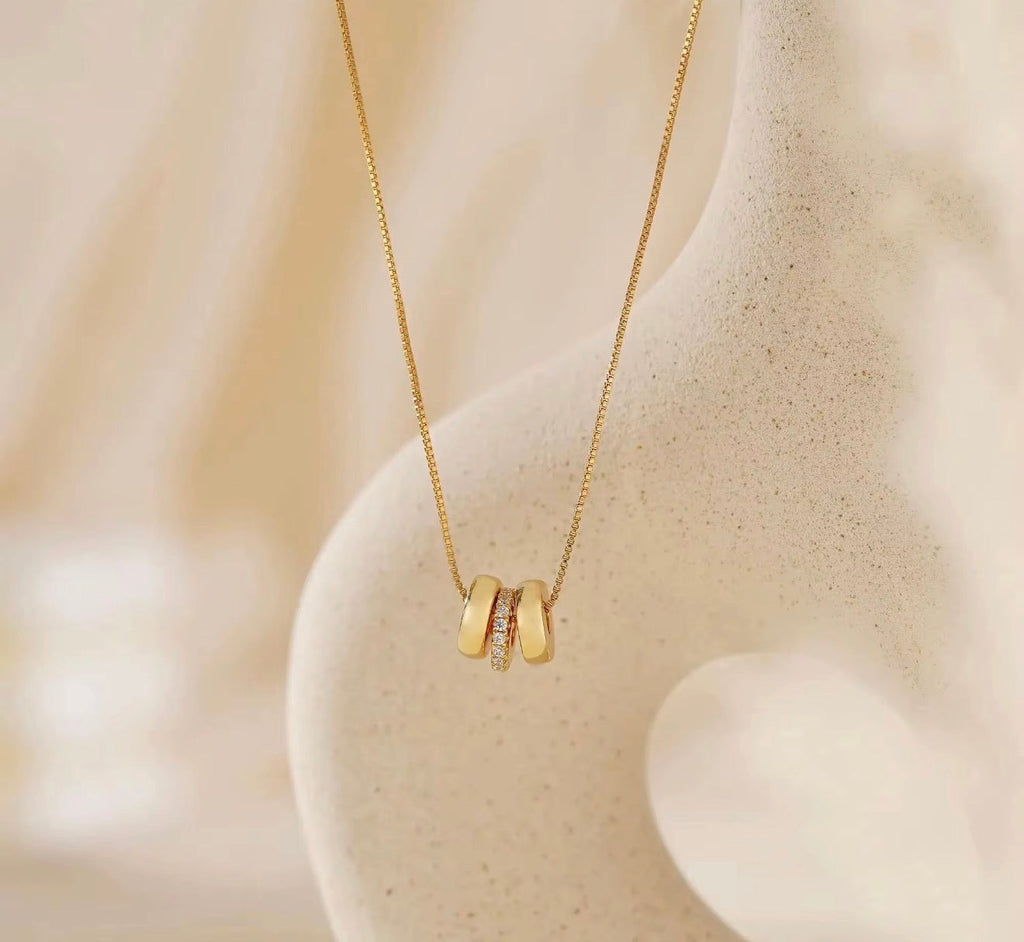 The Lyra gold personalized name bead necklace with crystal spacer