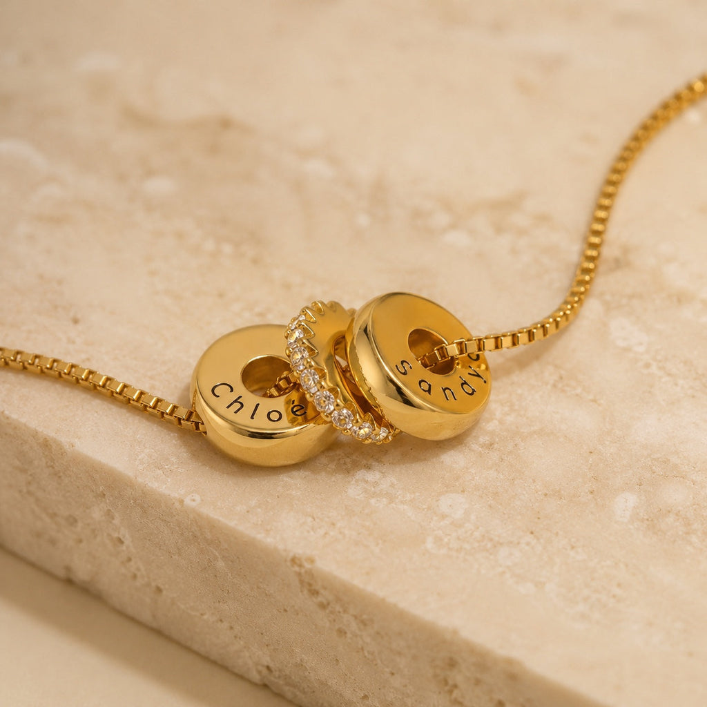 The Lyra personalized two-name gold necklace with crystal spacer