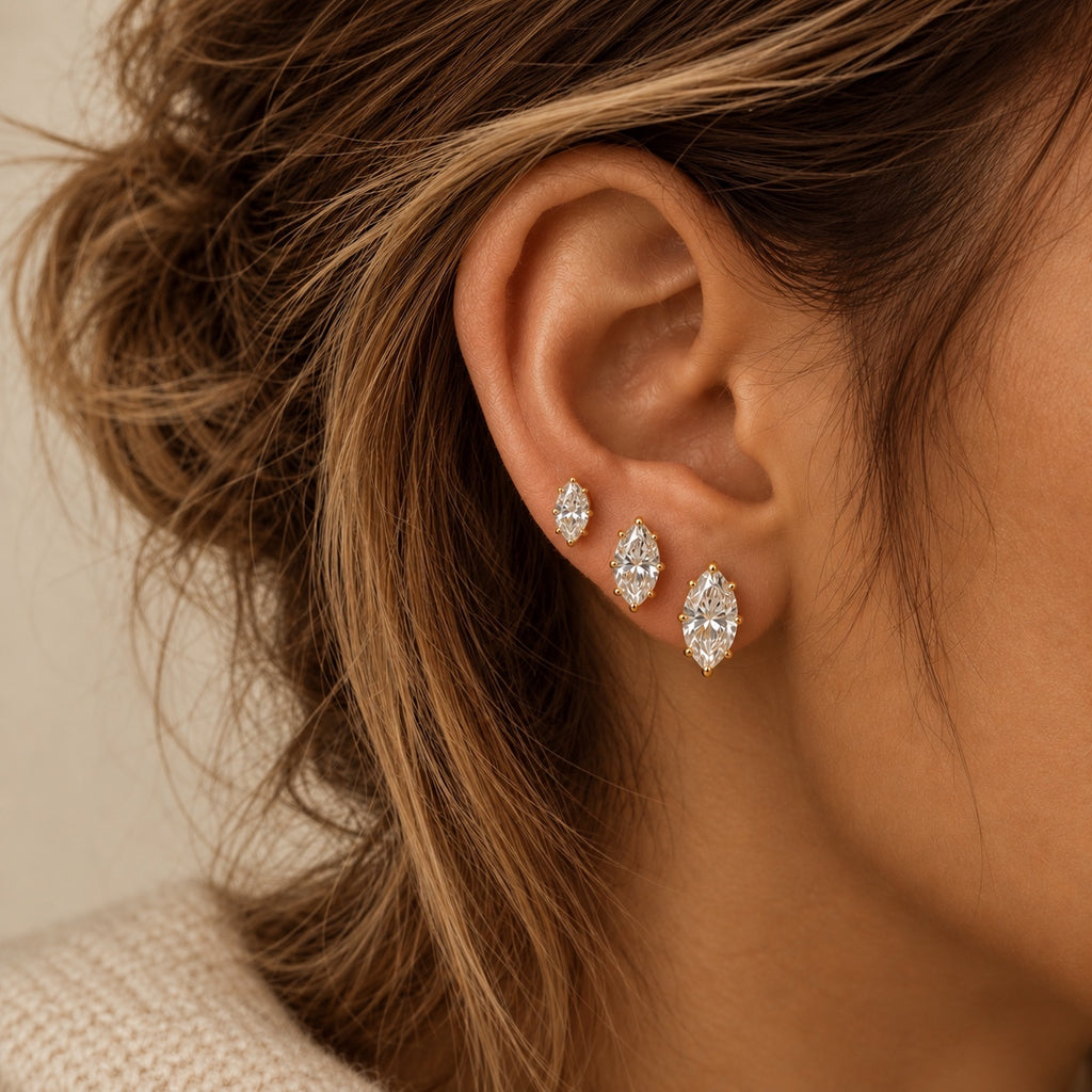 Marquise stud earrings worn together in three sizes