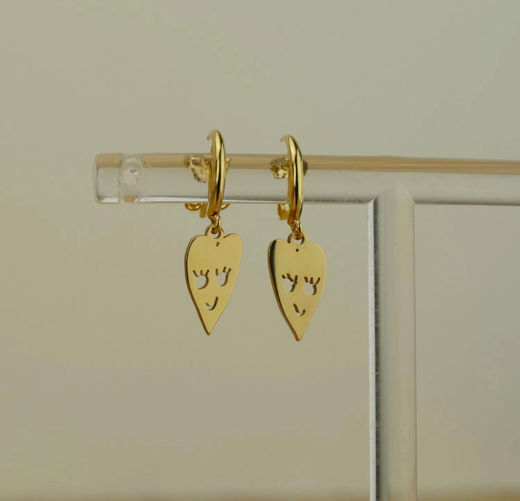 Gold personalized earrings with a child's heart drawing