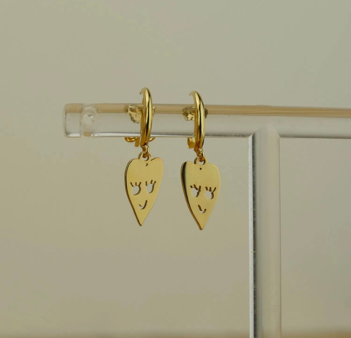 Gold personalized earrings with a child's heart drawing