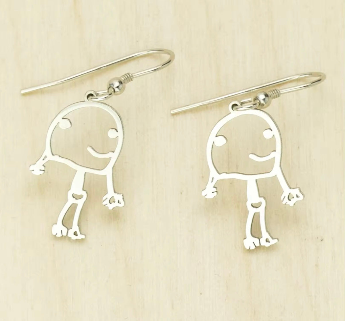 Silver personalized earrings created from a child's drawing
