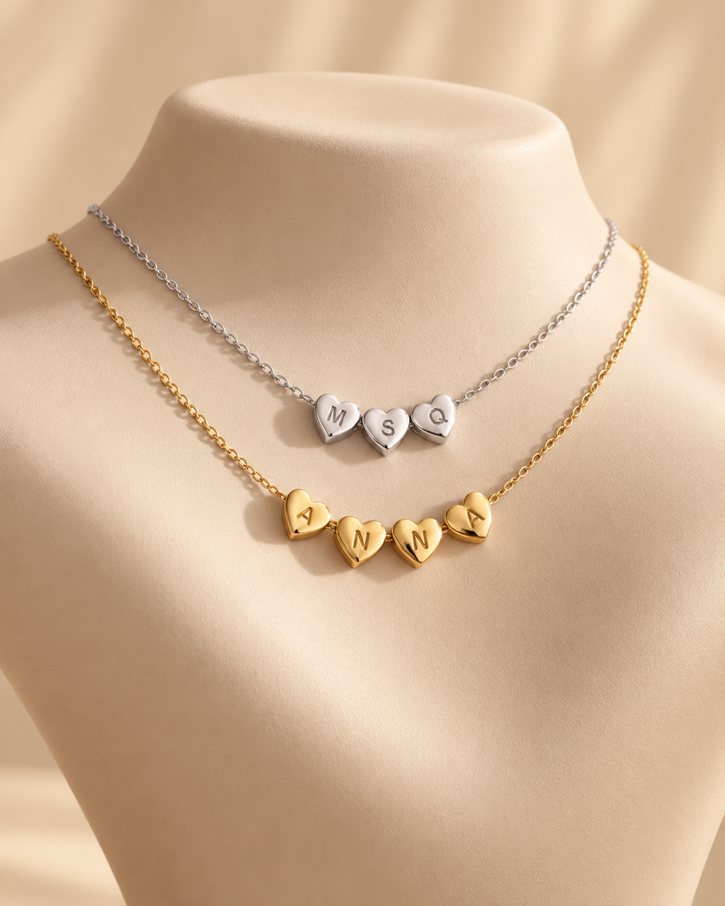 Gold and silver personalized heart initial necklaces displayed together