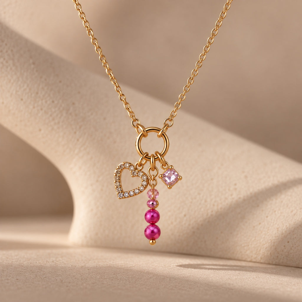 Close-up of The Rosalie pink and gold charm necklace