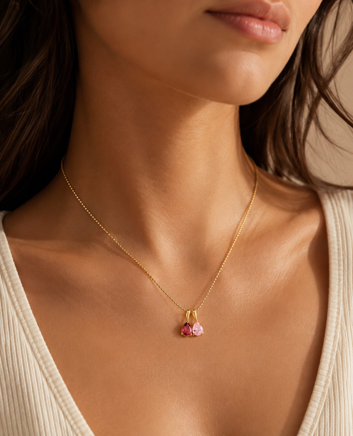 The Rosie personalized birthstone necklace with two teardrop stones worn on a model