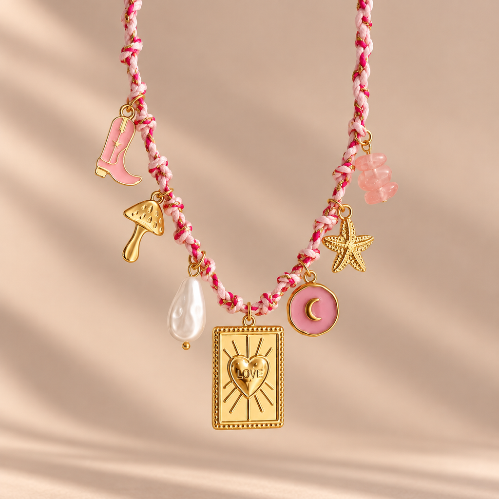Macro detail of pink and gold necklace charms
