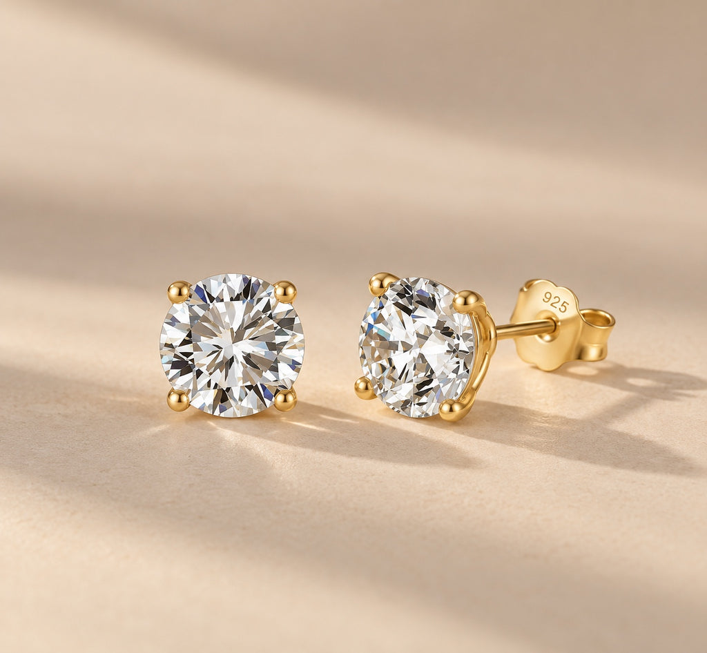 Claire round moissanite studs in gold