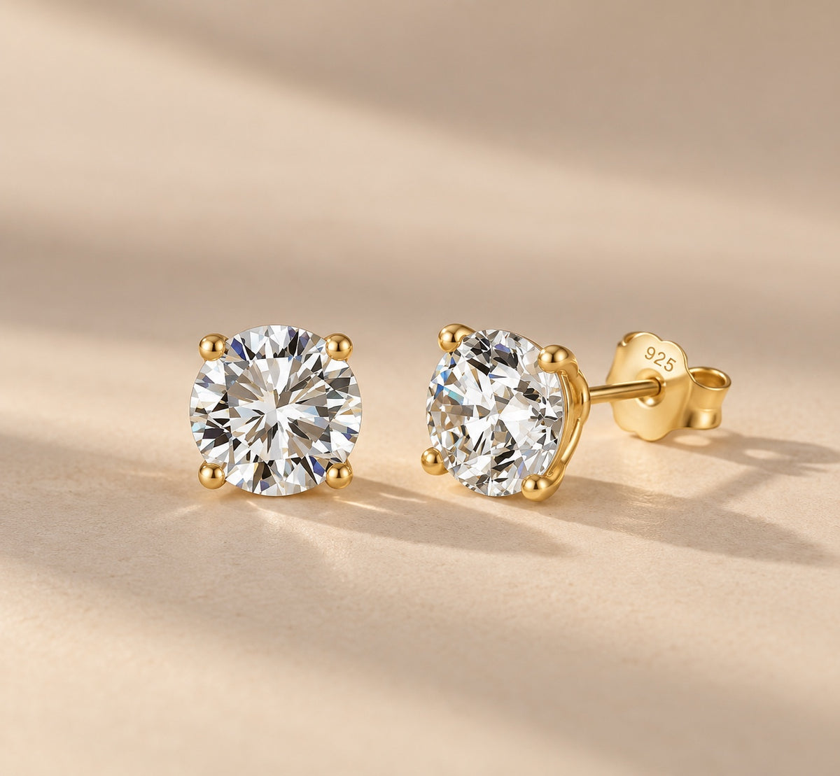 Claire round moissanite studs in gold