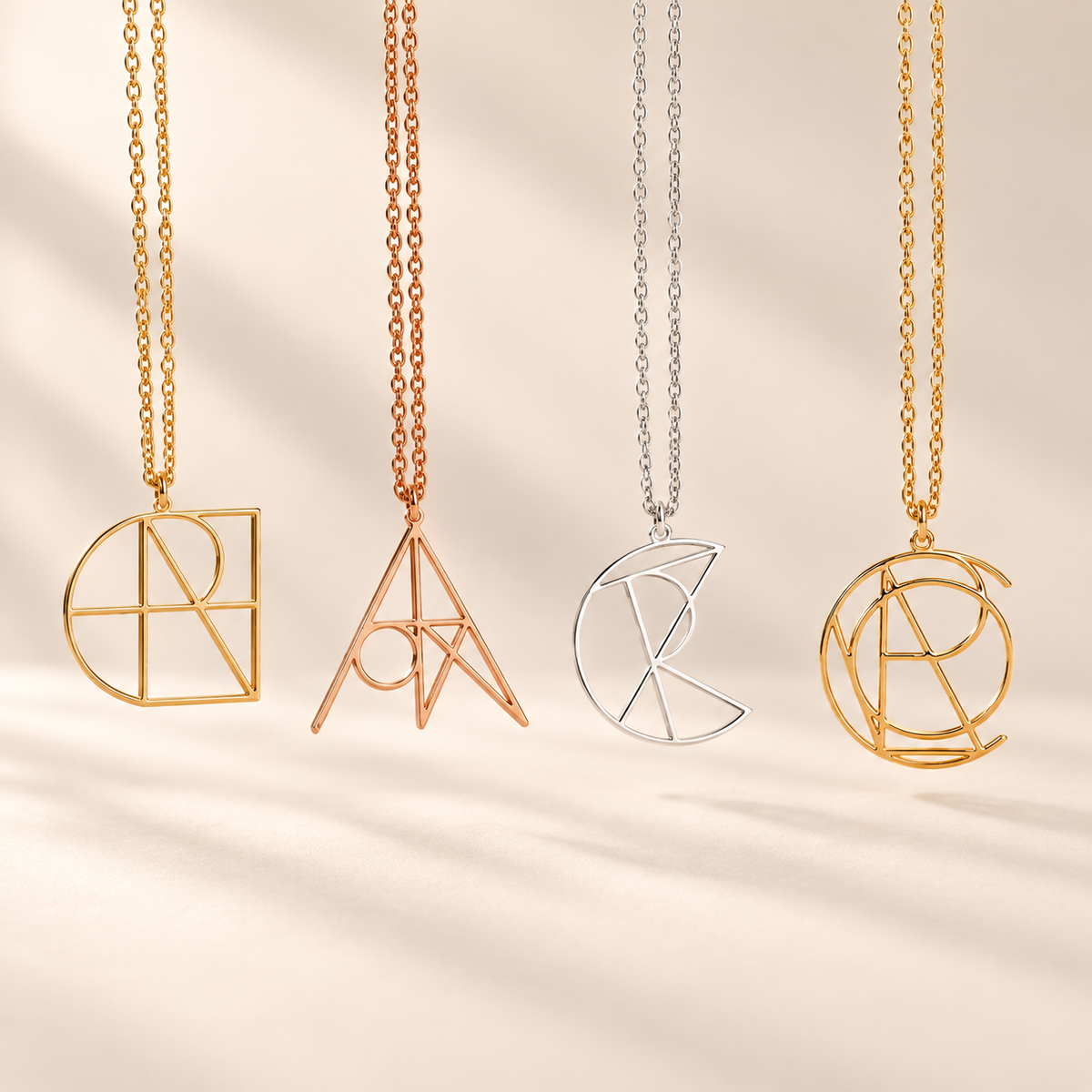 Personalized geometric name necklaces shown in gold, rose gold and silver