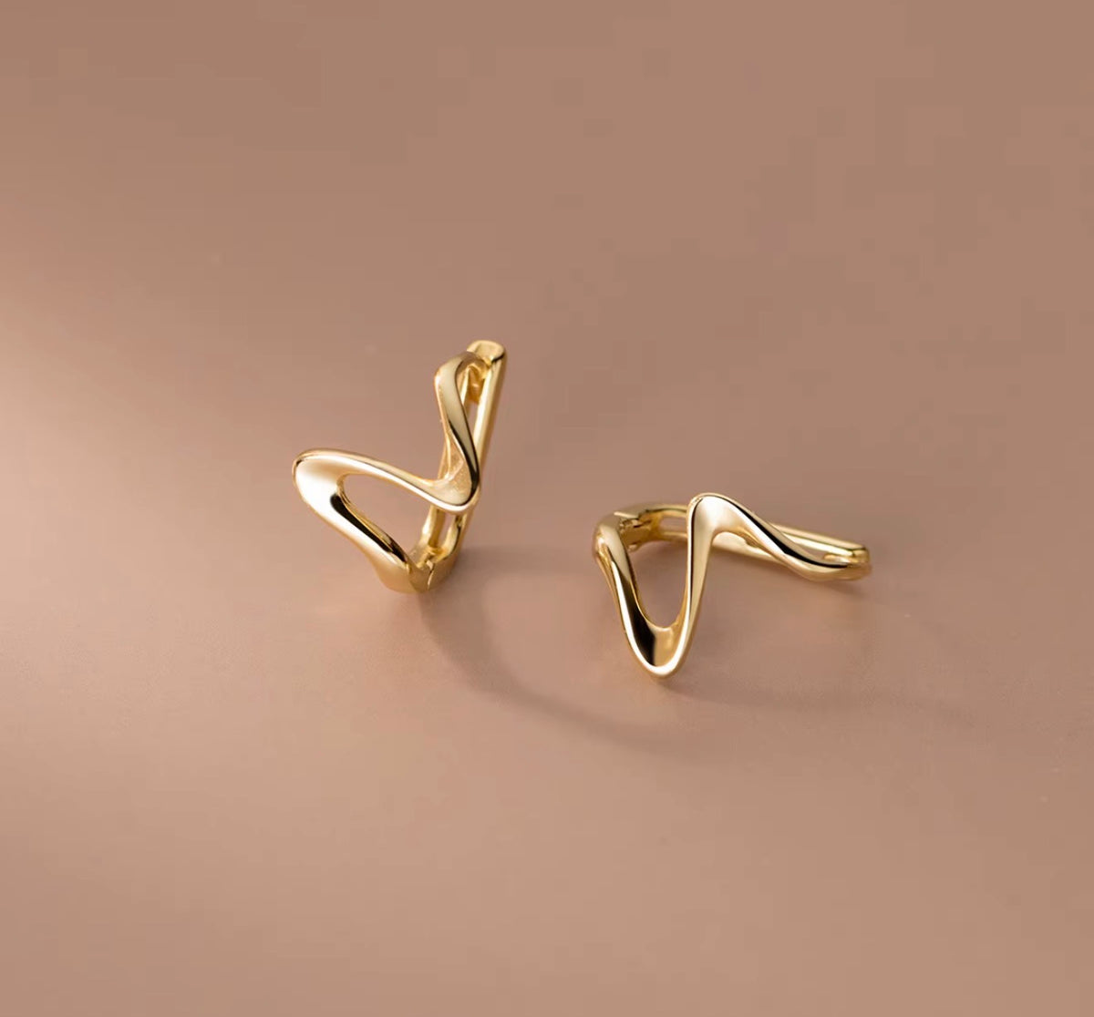 Gold sculptural wave hoop earrings