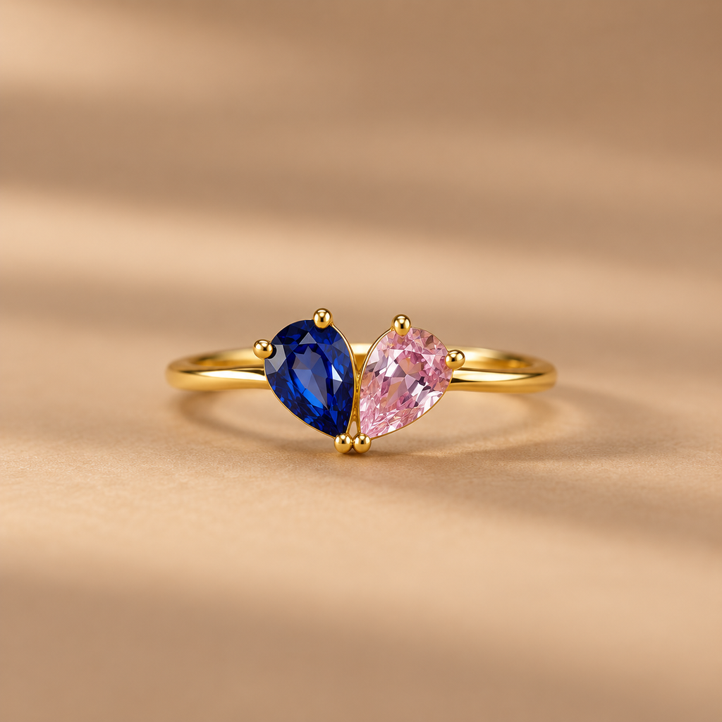 Close-up of Toi et Moi gold ring with blue and pink stones